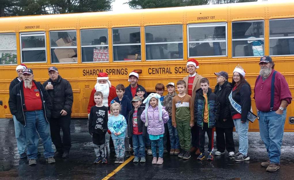 group of children and bus drivers outside the school bus