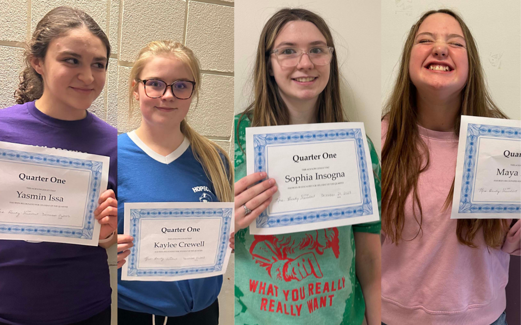 4 girls holding award certificates