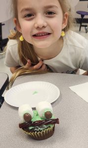 girl with a funny face cupcake