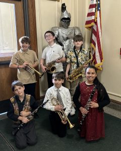 Six elementary band members with their instruments
