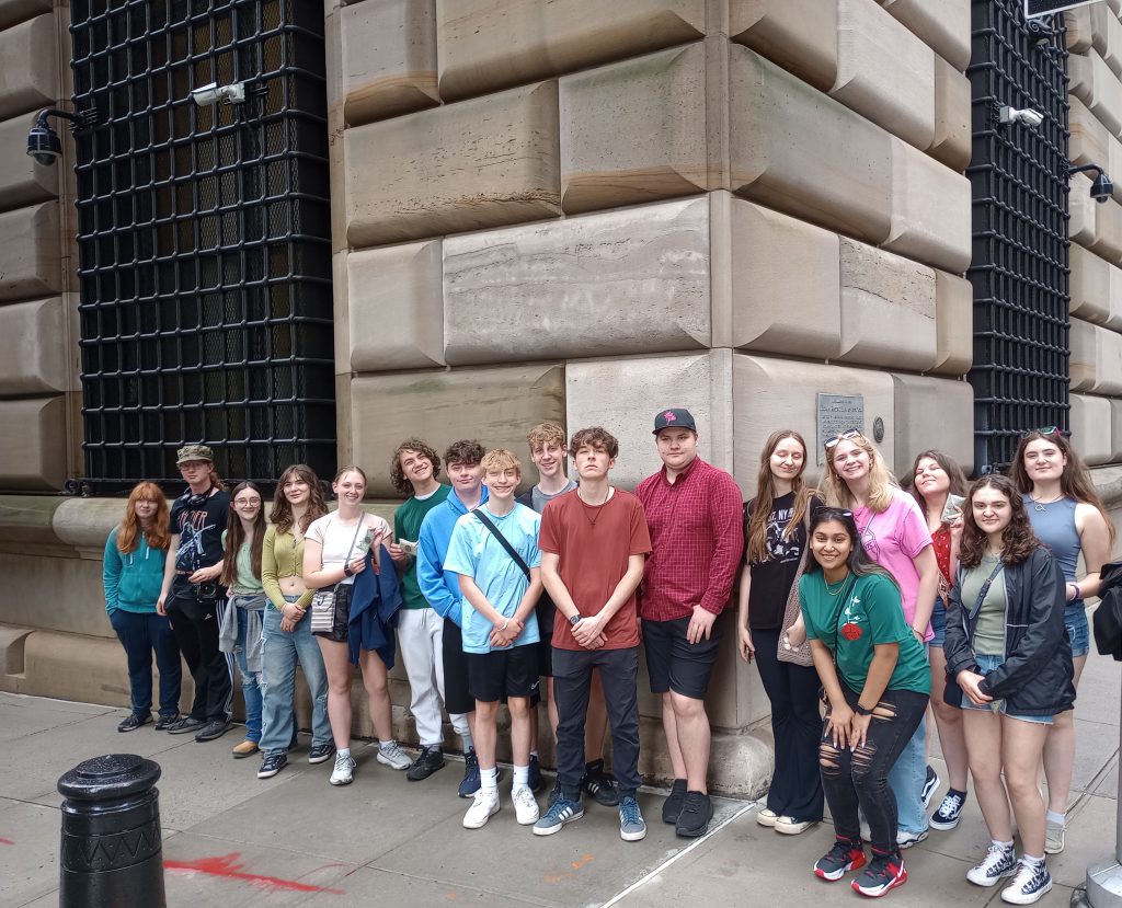 group of students stand outside the Federal Reserve Bank in New York City