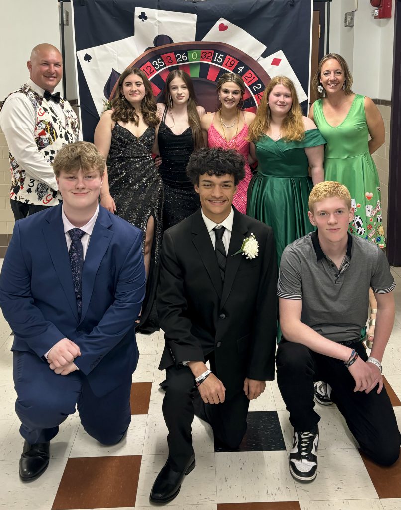 group of staff and student dressed in casino theme clothing at prom