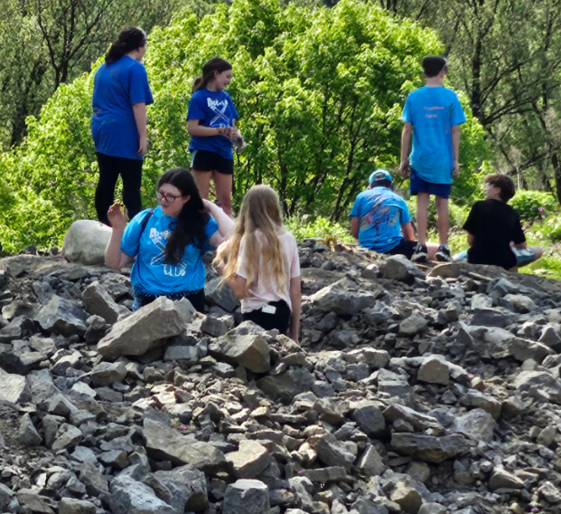 group of student sift through rocks 