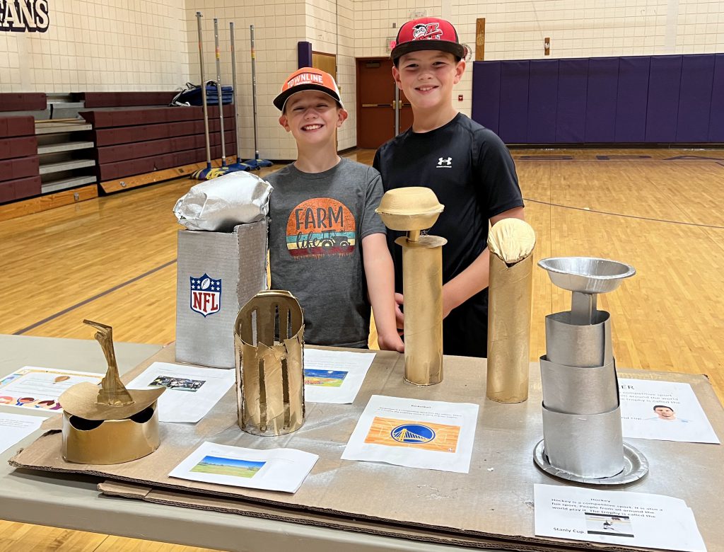 two boys with their cardboard display