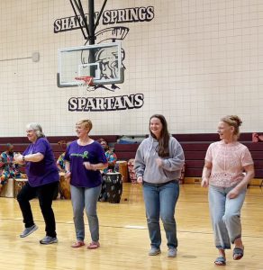 four teacher dancing on the gym floor