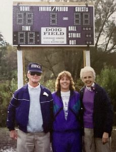 three coaches in front of scoreboard