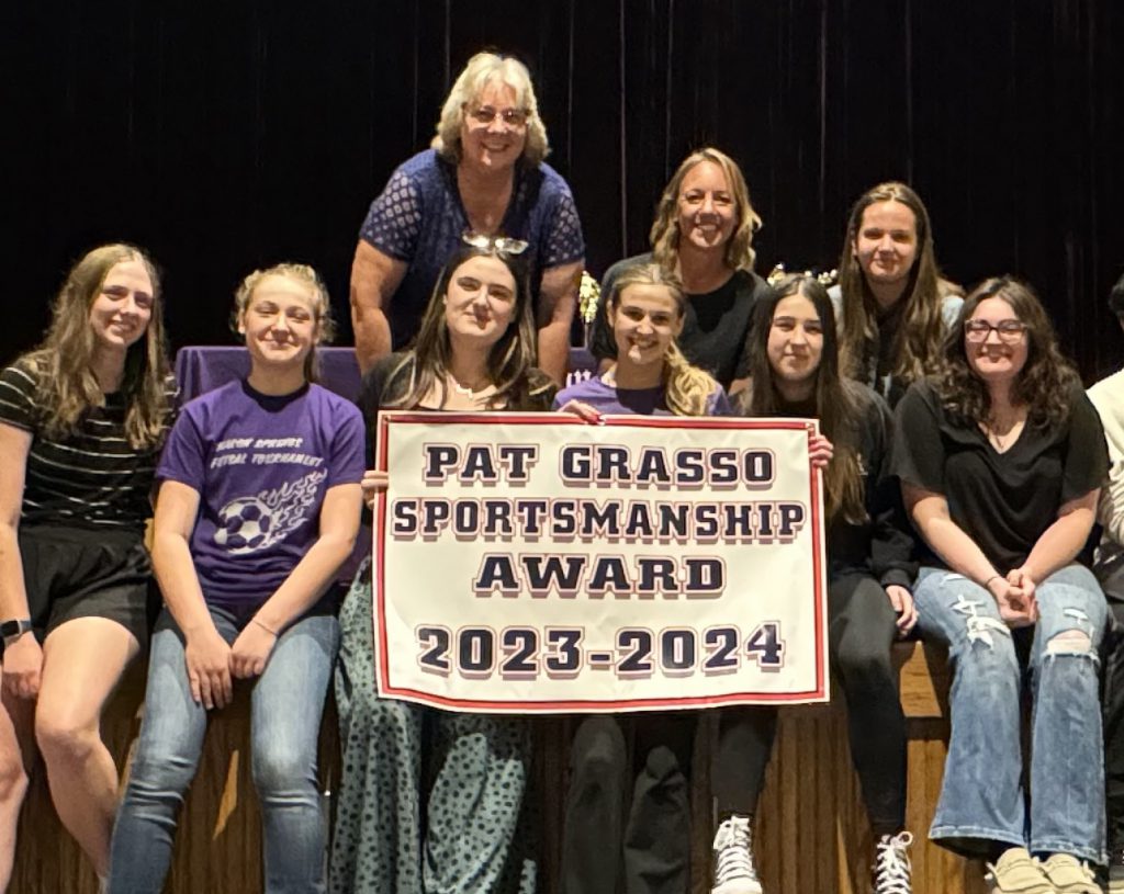 coach and team hold up the sportmanship award