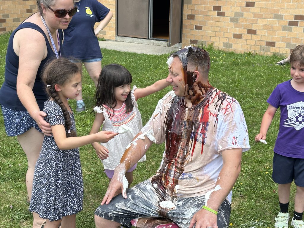 Principal gets sundae toppings poured on him