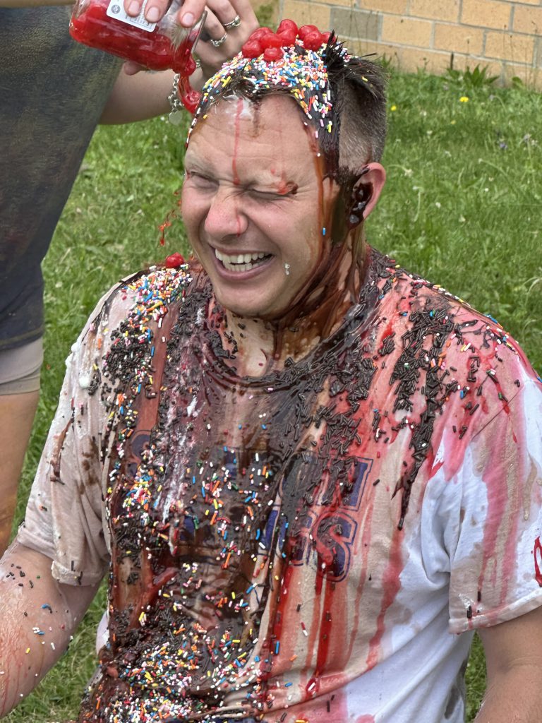 Principal gets sundae toppings poured on him