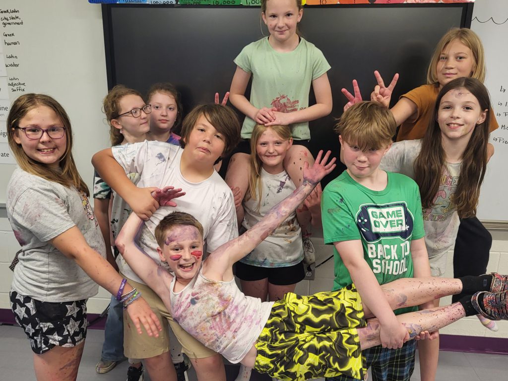 group of kids covered in paint