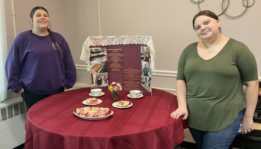 two girls show off their Ag display