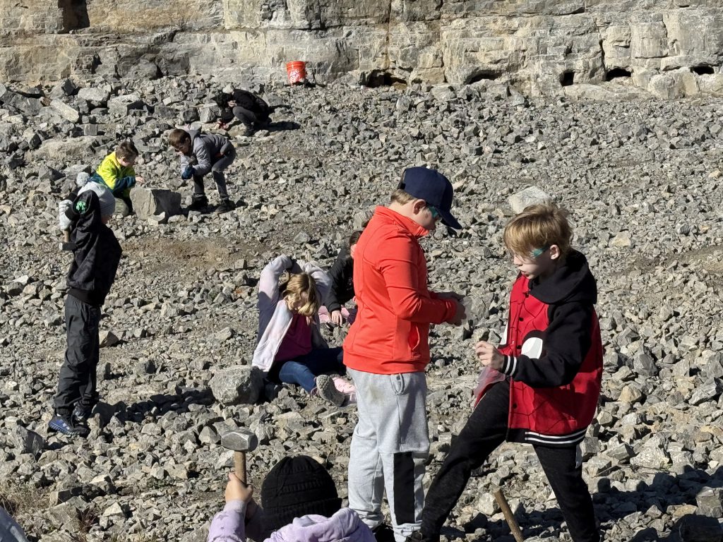 group of student explore rocks at a mine