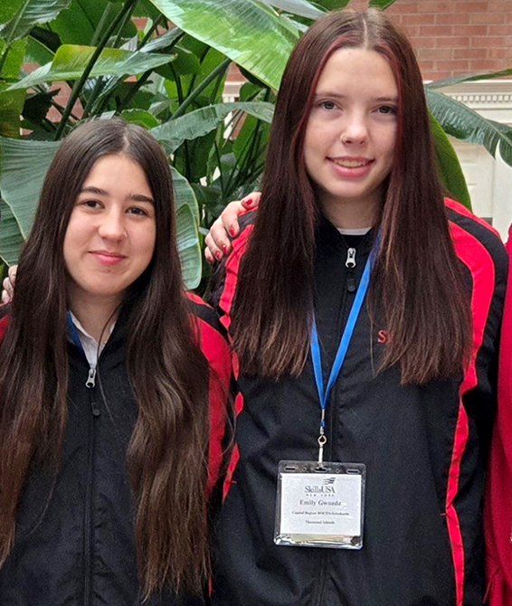 Two girls pose at conference