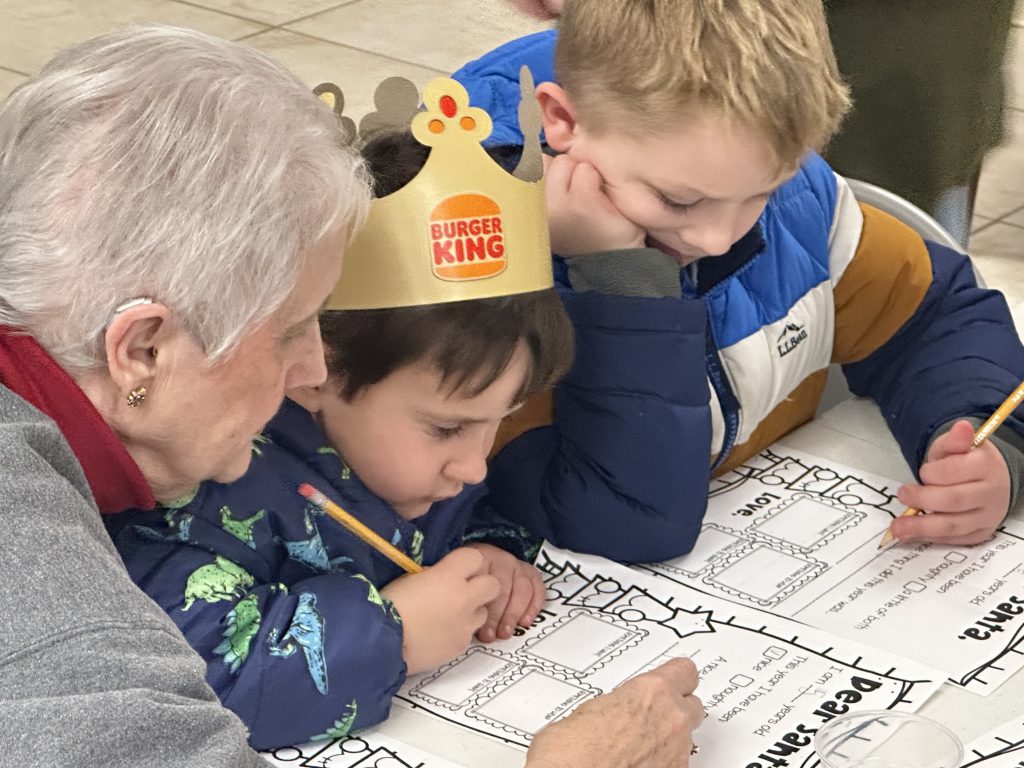 woman work on project with two children