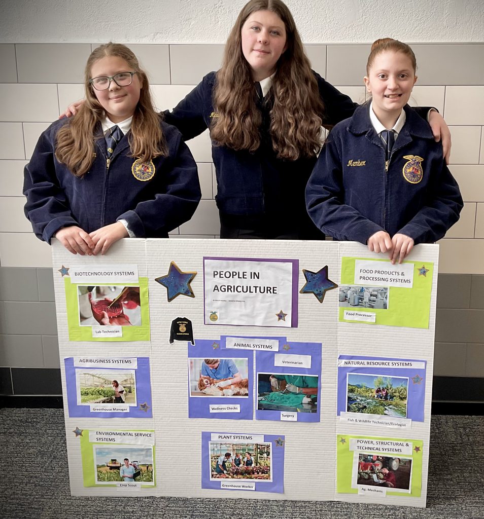 three FFA girls with their contest poster