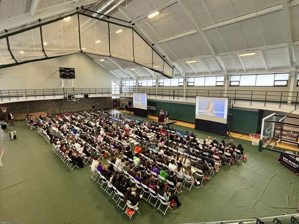 large group of attendees spread gym floor at a conference