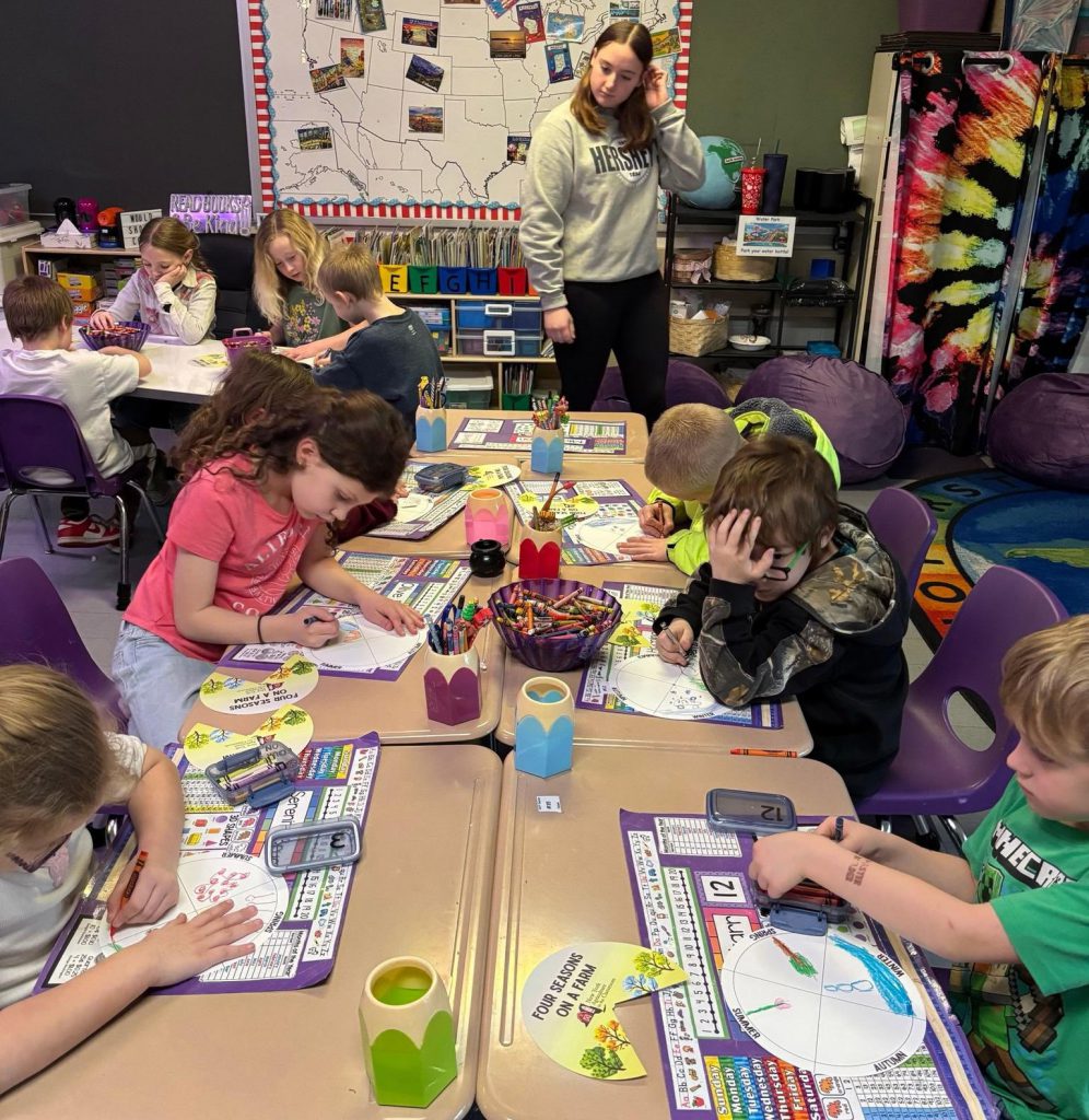 group of children work on an art project at a table