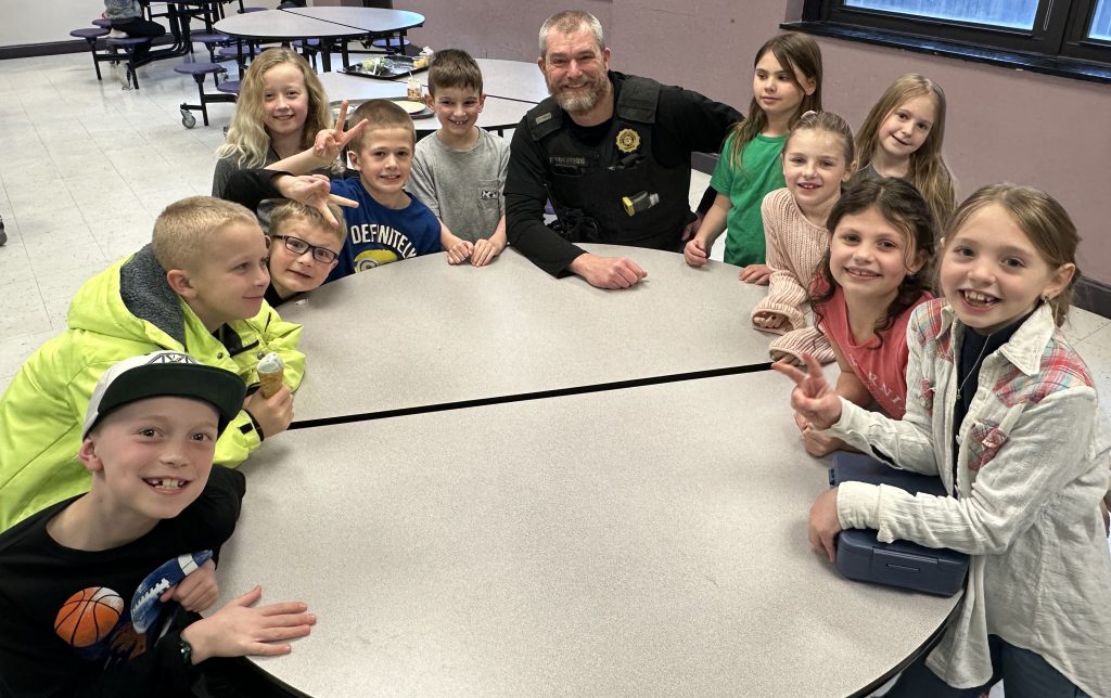 Probation Officer Joseph Kenyon visits with elementary youngsters diuring lunch break