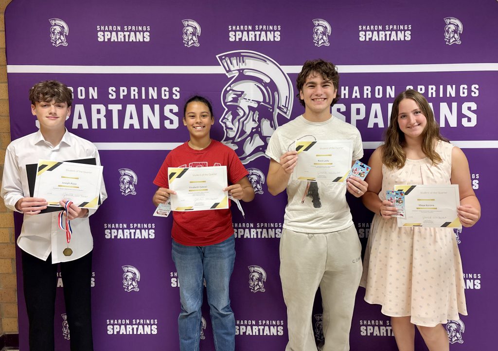 four students hold their award certificates